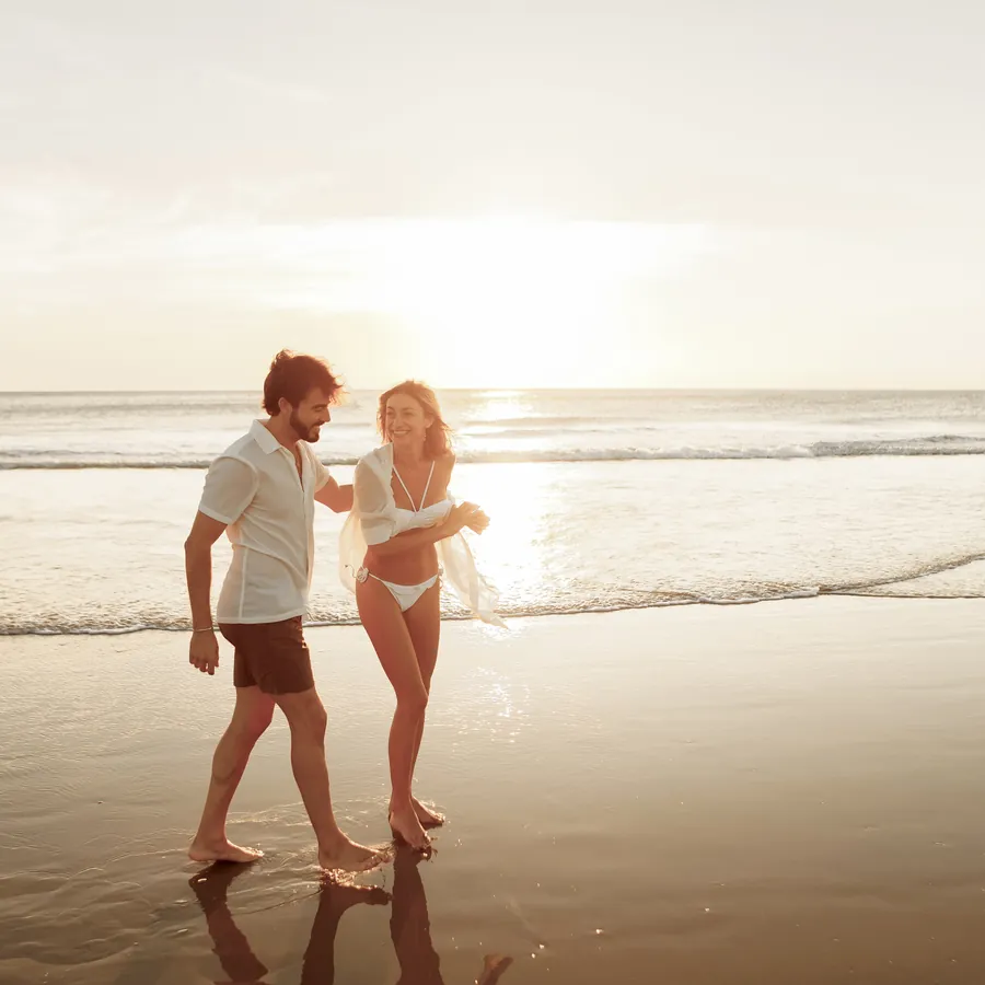 Couple walking on the beach at an Iberostar resort, Iberostar The Club