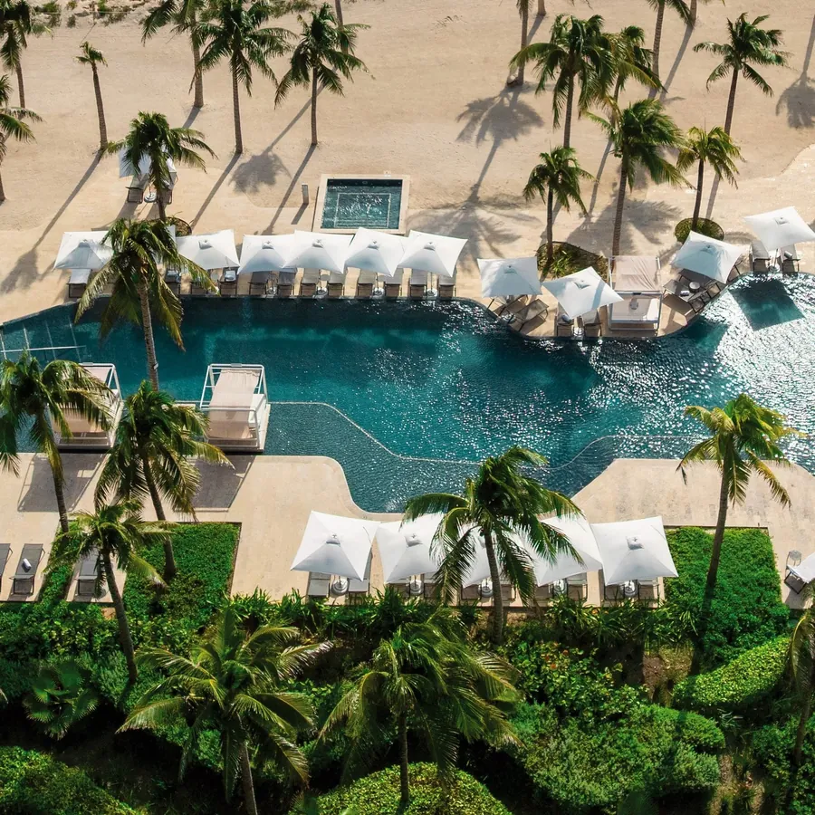 Pool and palm trees at Hilton Tulum All-Inclusive